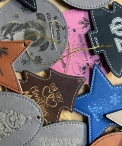 Mix of engraved leatherette Christmas ornaments in stars, trees and rounds