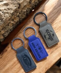 Gray and purple engraved vegan leatherette keychains with football and soccer designs