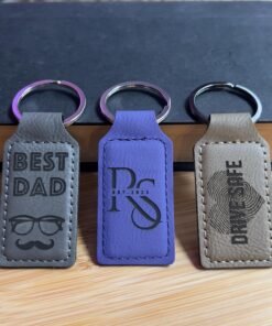 Gray, purple and tan vegan leatherette keychains engraved with Best Dad, an RS monogram and Drive Safe