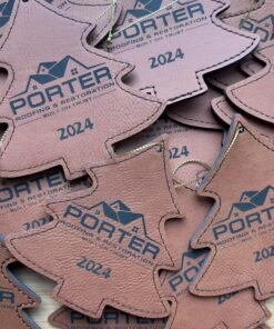 Brown leatherette Christmas tree ornaments engraved with a sample business logo and 2024