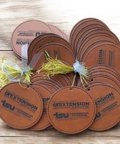 Round brown leatherette Christmas ornaments engraved with a sample organization logo