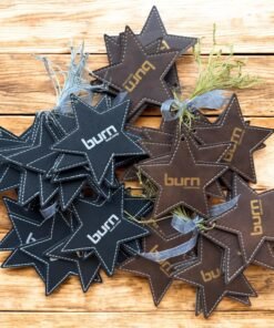 Black and brown leatherette star ornaments engraved with a sample business logo
