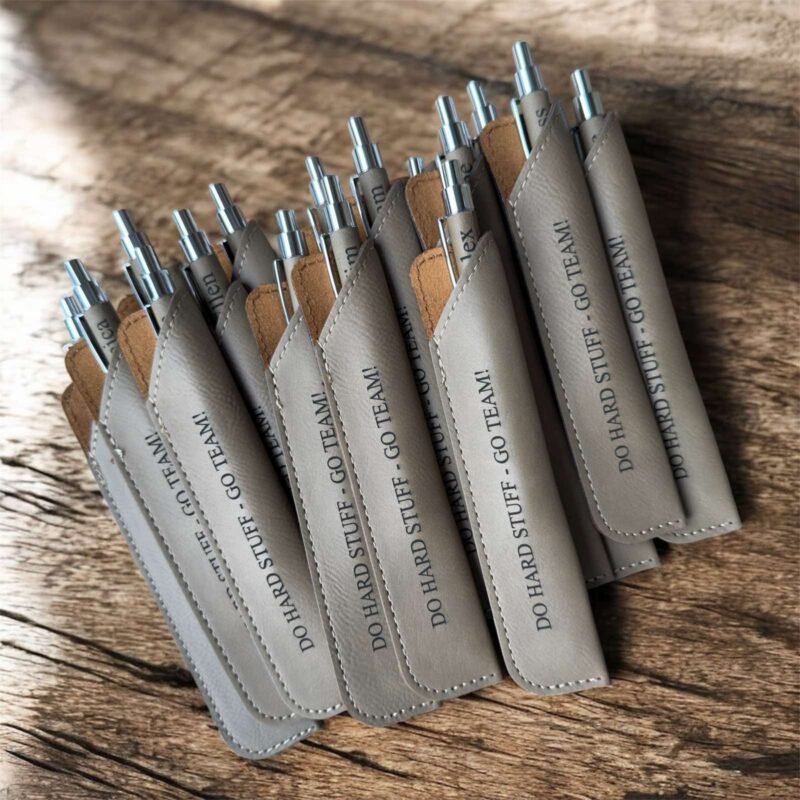 Engraved logo pens with gray leatherette pen sleeves, bulk order for an office team